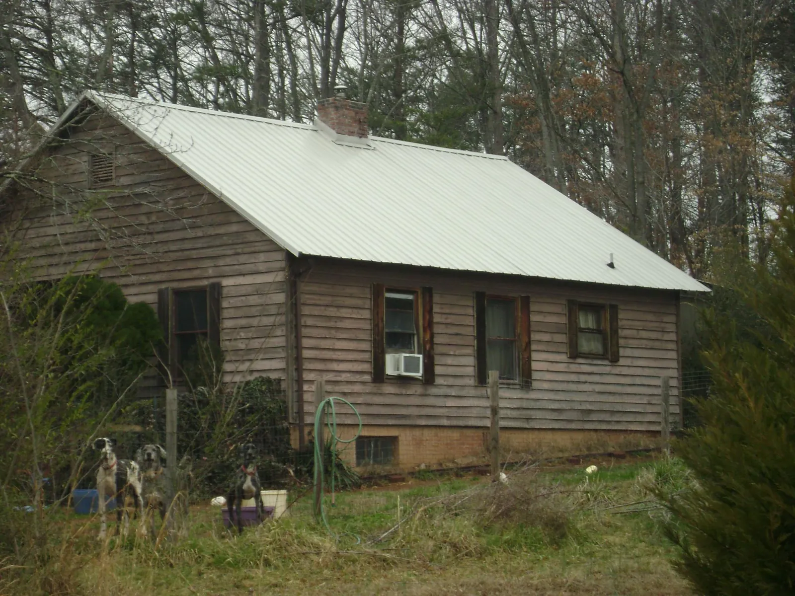 White metal roof on an old wood sided farmhouse, from a Asphalt Shingle Roof Repair job in Grand Island